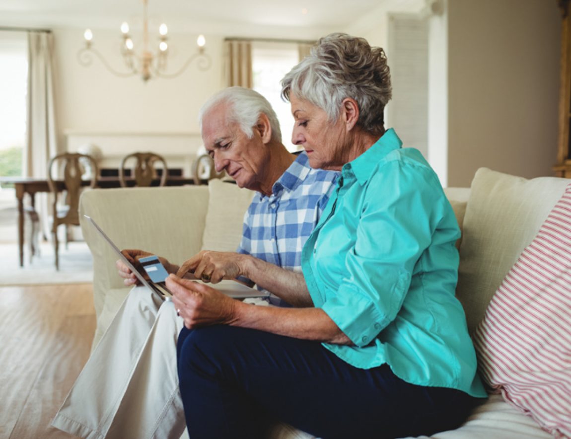 Senior couple doing online shopping on laptop