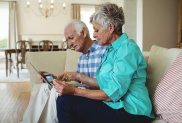 Senior couple doing online shopping on laptop