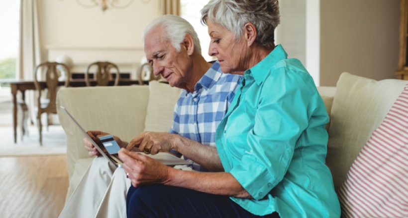 Senior couple doing online shopping on laptop