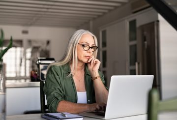 Worried senior woman using laptop