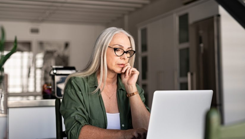 Worried senior woman using laptop